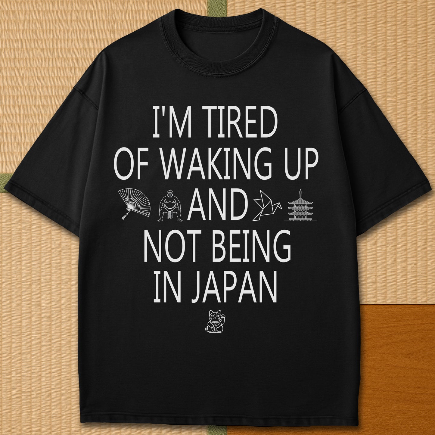 Japanese-inspired cotton Tired Waking Up Not In Japan T-Shirt in Black on Comfort Colors 1717, styled in a modern flatlay scene.