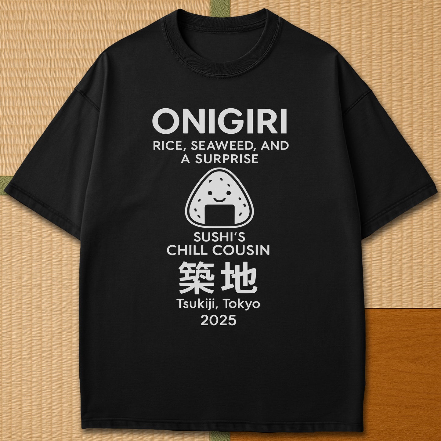 Japanese-inspired cotton Onigiri Chill Cousin Of Sushi T-Shirt in Black on Comfort Colors 1717, styled in a modern flatlay scene.