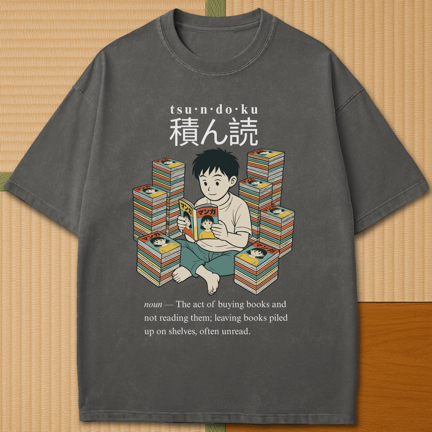 Japanese-inspired cotton Tsundoku Boy Manga Collector T-Shirt in Pepper on Comfort Colors 1717, styled in a modern flatlay scene.