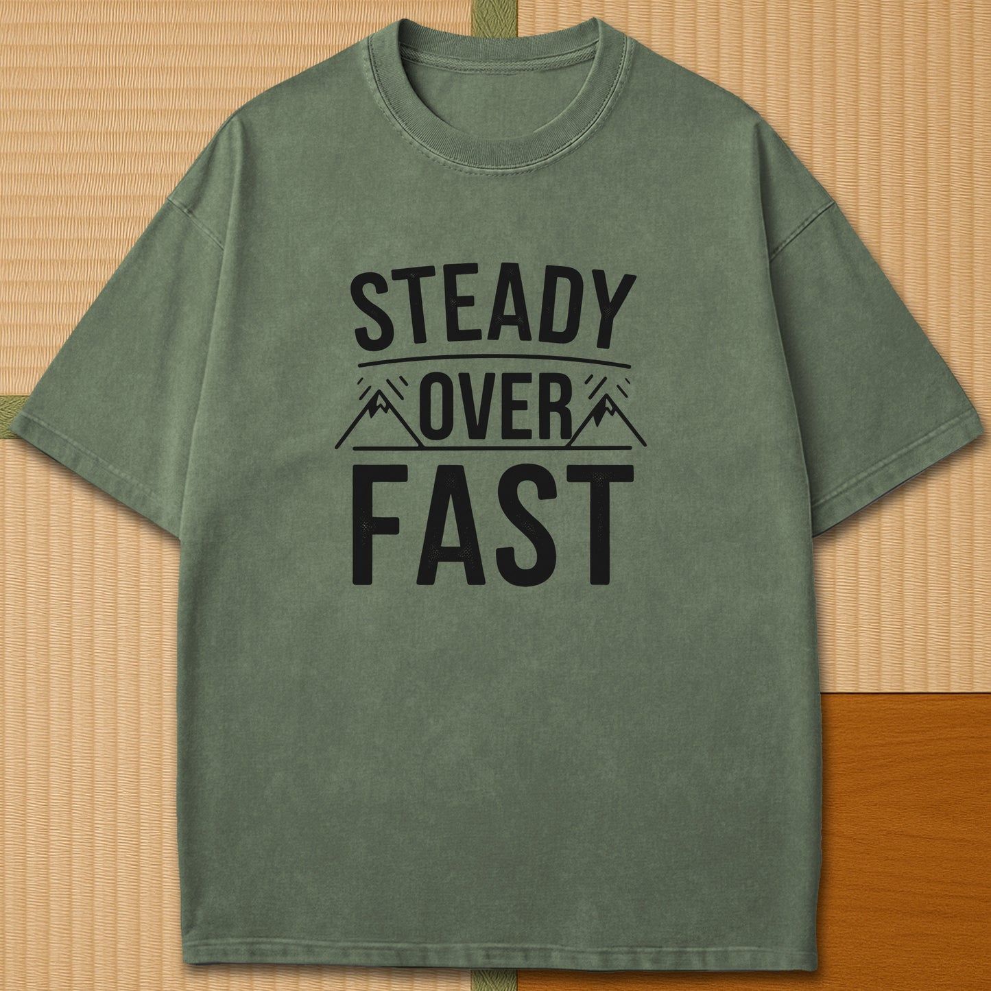 Japanese-inspired cotton Steady Over Fast T-Shirt in Moss on Comfort Colors 1717, styled in a modern flatlay scene.