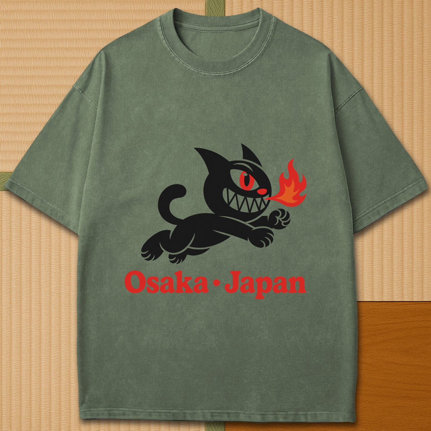 Japanese-inspired cotton Mischievous Cat Osaka T-Shirt in Moss on Comfort Colors 1717, styled in a modern flatlay scene.