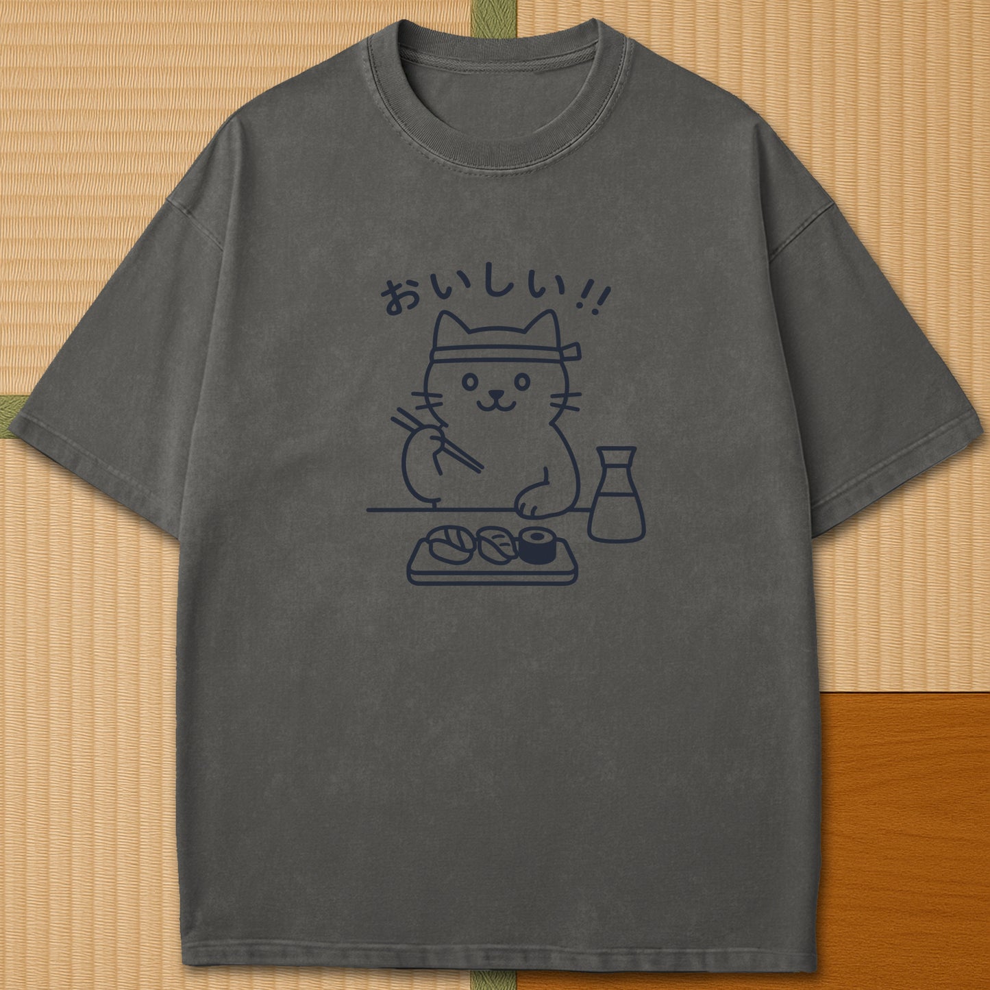 Japanese-inspired cotton Minimalist Cat & Sushi T-Shirt in Pepper on Comfort Colors 1717, styled in a modern flatlay scene.