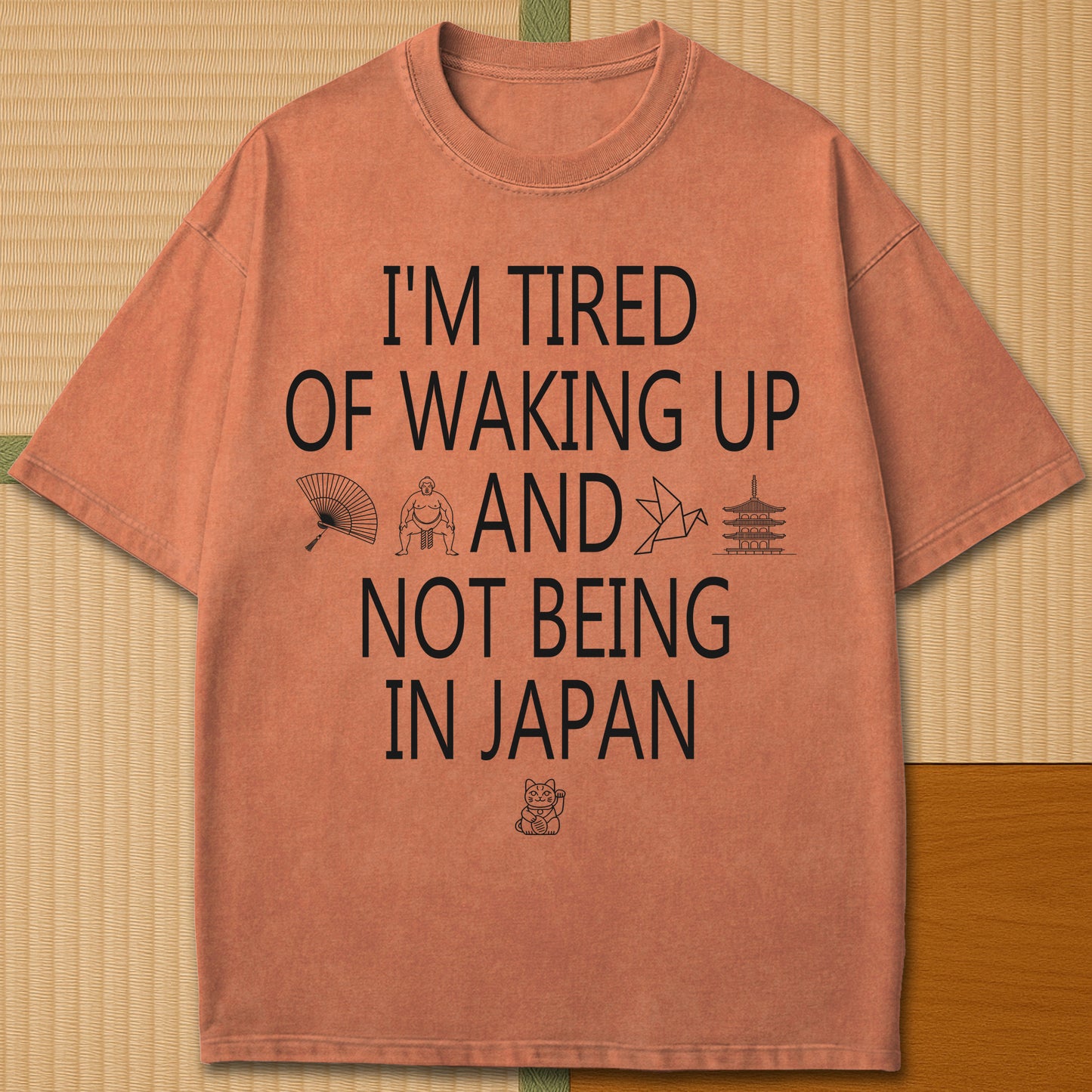 Japanese-inspired cotton Tired Waking Up Not In Japan T-Shirt in Yam on Comfort Colors 1717, styled in a modern flatlay scene.