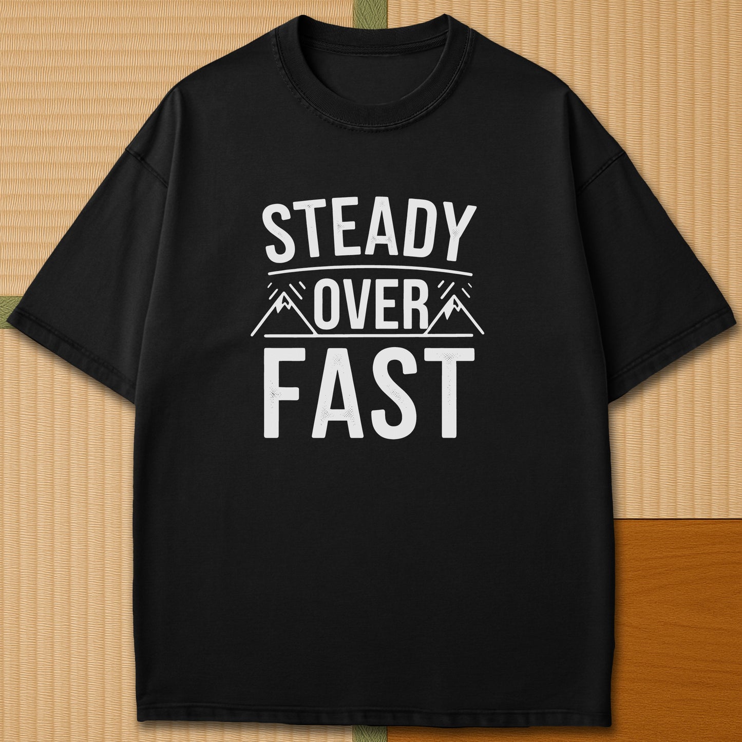 Japanese-inspired cotton Steady Over Fast T-Shirt in Black on Comfort Colors 1717, styled in a modern flatlay scene.
