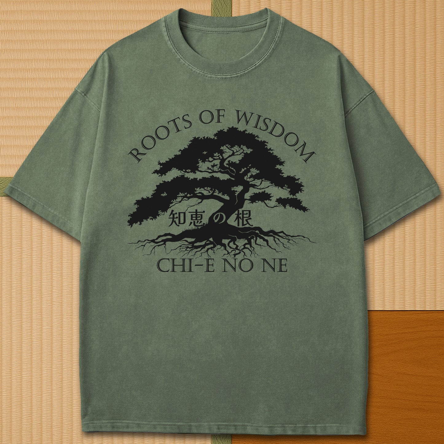 Japanese-inspired cotton Roots Of Wisdom T-Shirt in Moss on Comfort Colors 1717, styled in a modern flatlay scene.