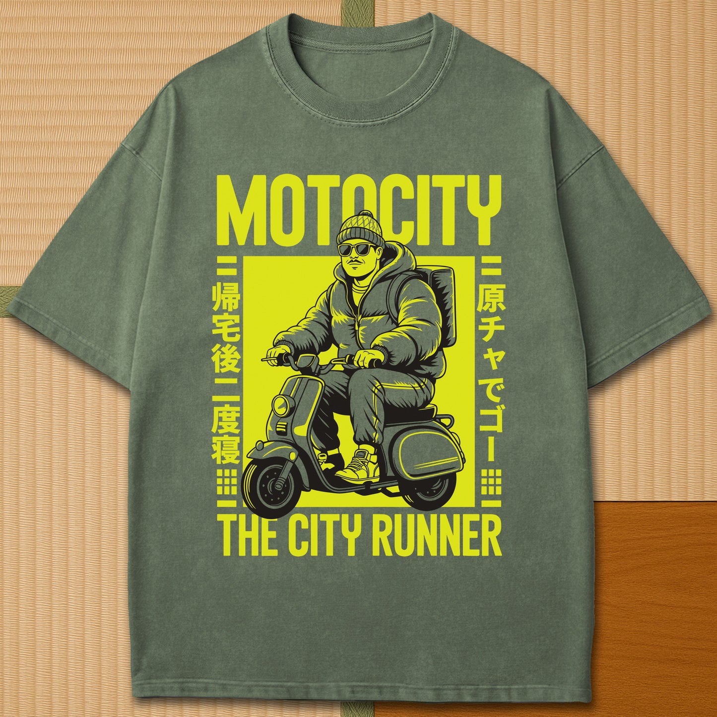Japanese-inspired cotton Motocity The City Runner T-Shirt in Moss on Comfort Colors 1717, styled in a modern flatlay scene.