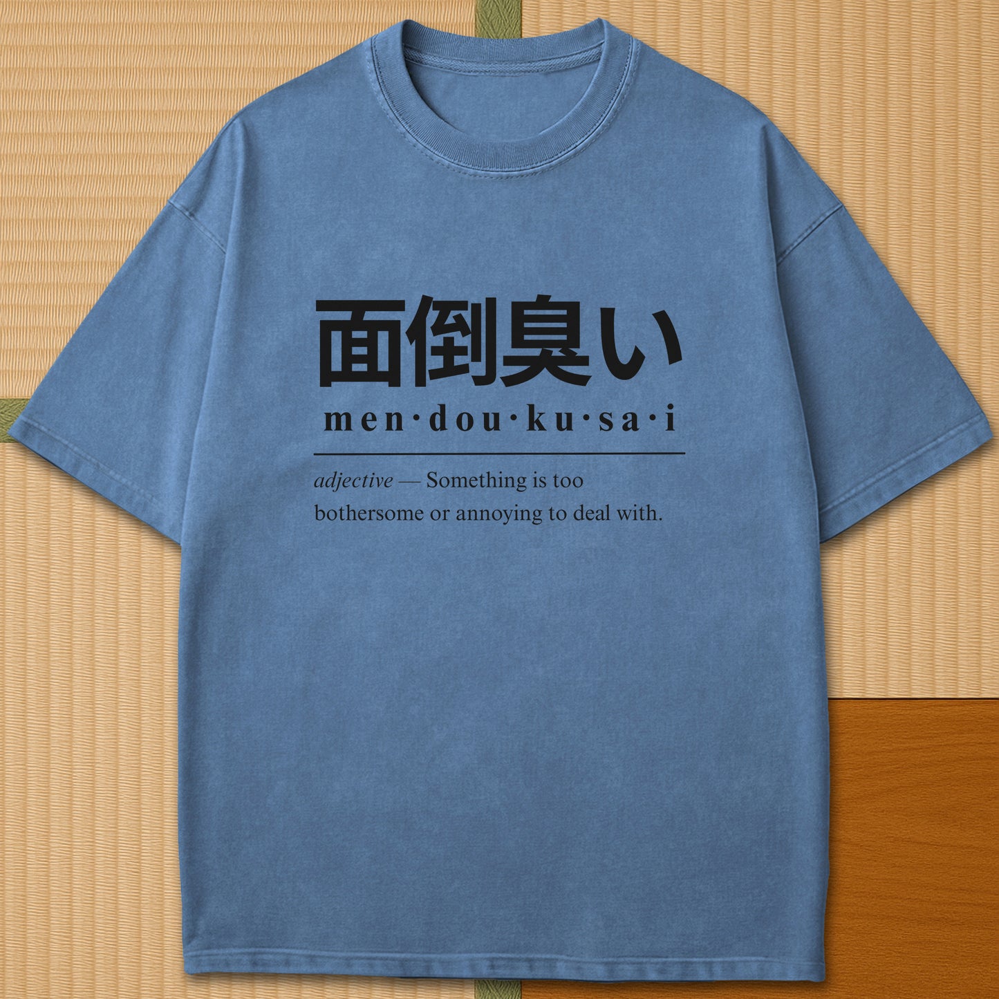 Japanese-inspired cotton Mendoukusai Japanese Dictionary T-Shirt in Blue Jean on Comfort Colors 1717, styled in a modern flatlay scene.