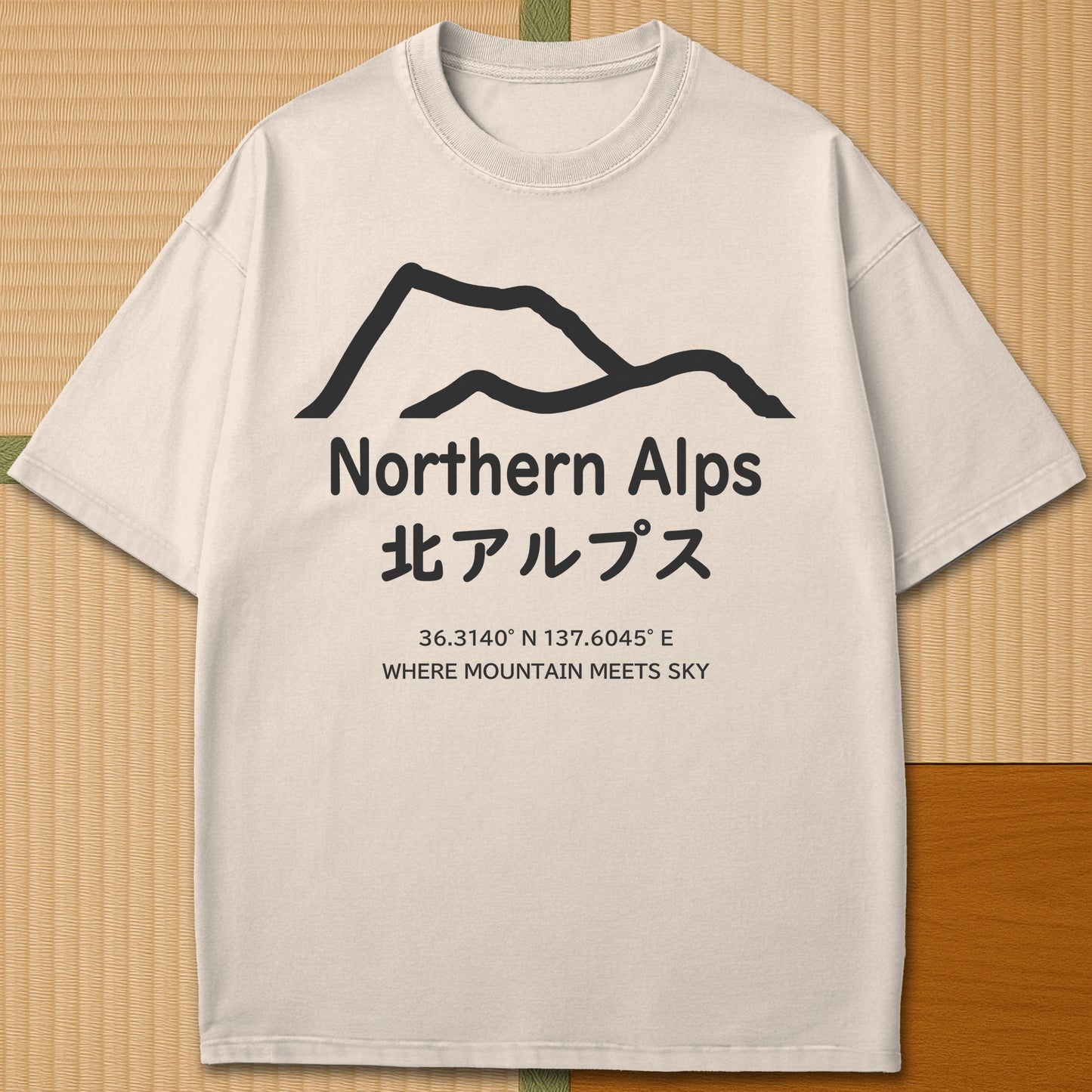 Japanese-inspired cotton Northern Alps Japan T-Shirt in Ivory on Comfort Colors 1717, styled in a modern flatlay scene.