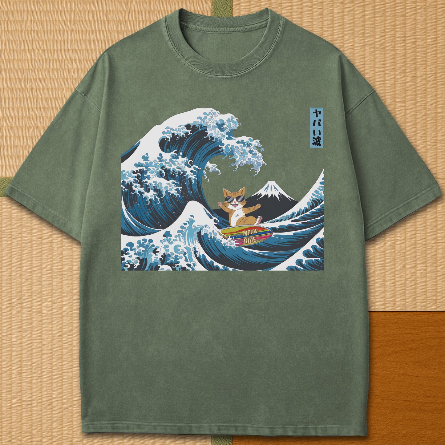 Japanese-inspired cotton Meow Ride T-Shirt in Moss on Comfort Colors 1717, styled in a modern flatlay scene.