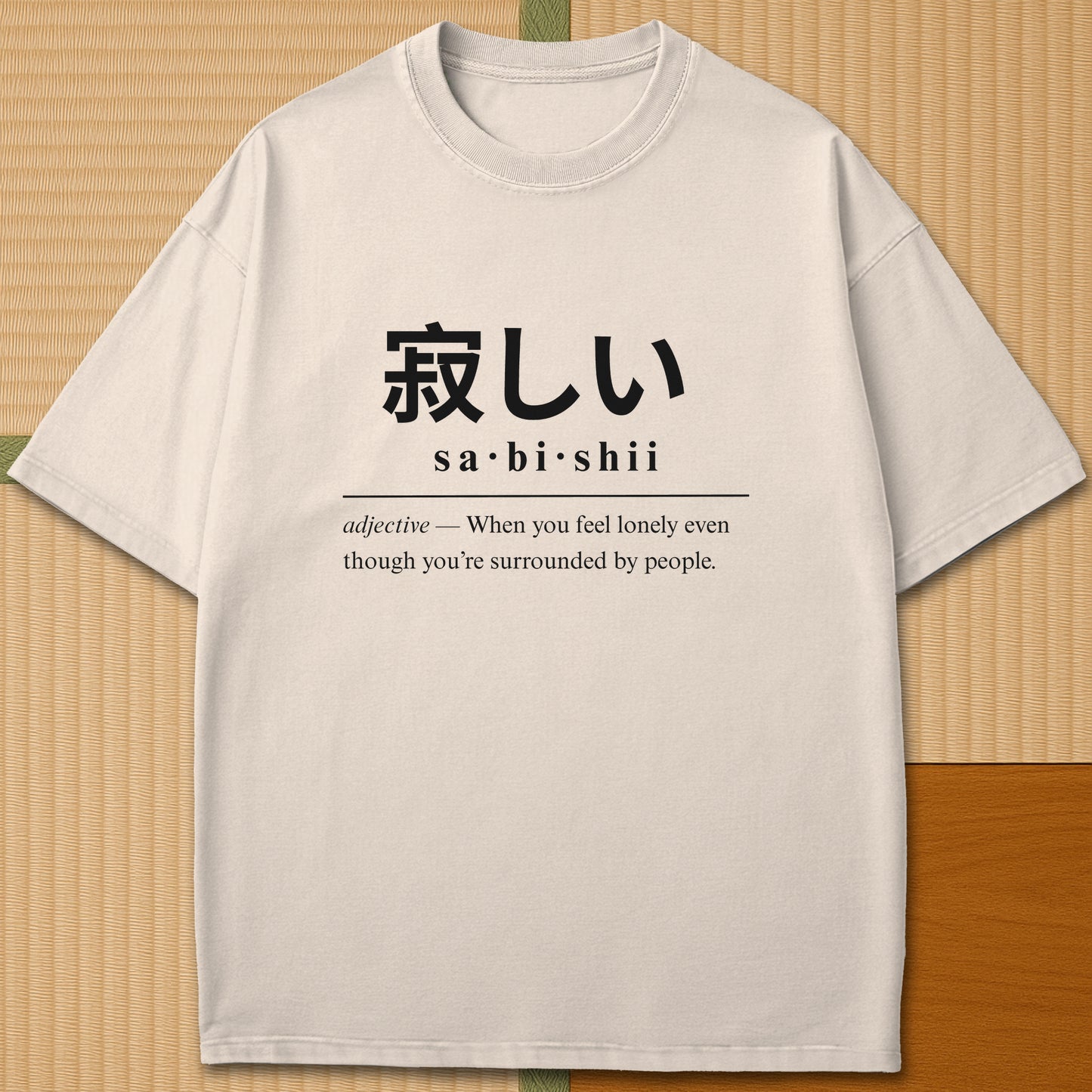 Japanese-inspired cotton Sabishii Japanese Dictionary T-Shirt in Ivory on Comfort Colors 1717, styled in a modern flatlay scene.