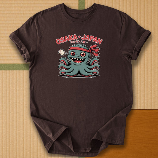 Japanese-inspired cotton Takoyaki Terror Playful Japan Kaiju T-Shirt in Dark Chocolate on Gildan 64000, styled in a modern flatlay scene