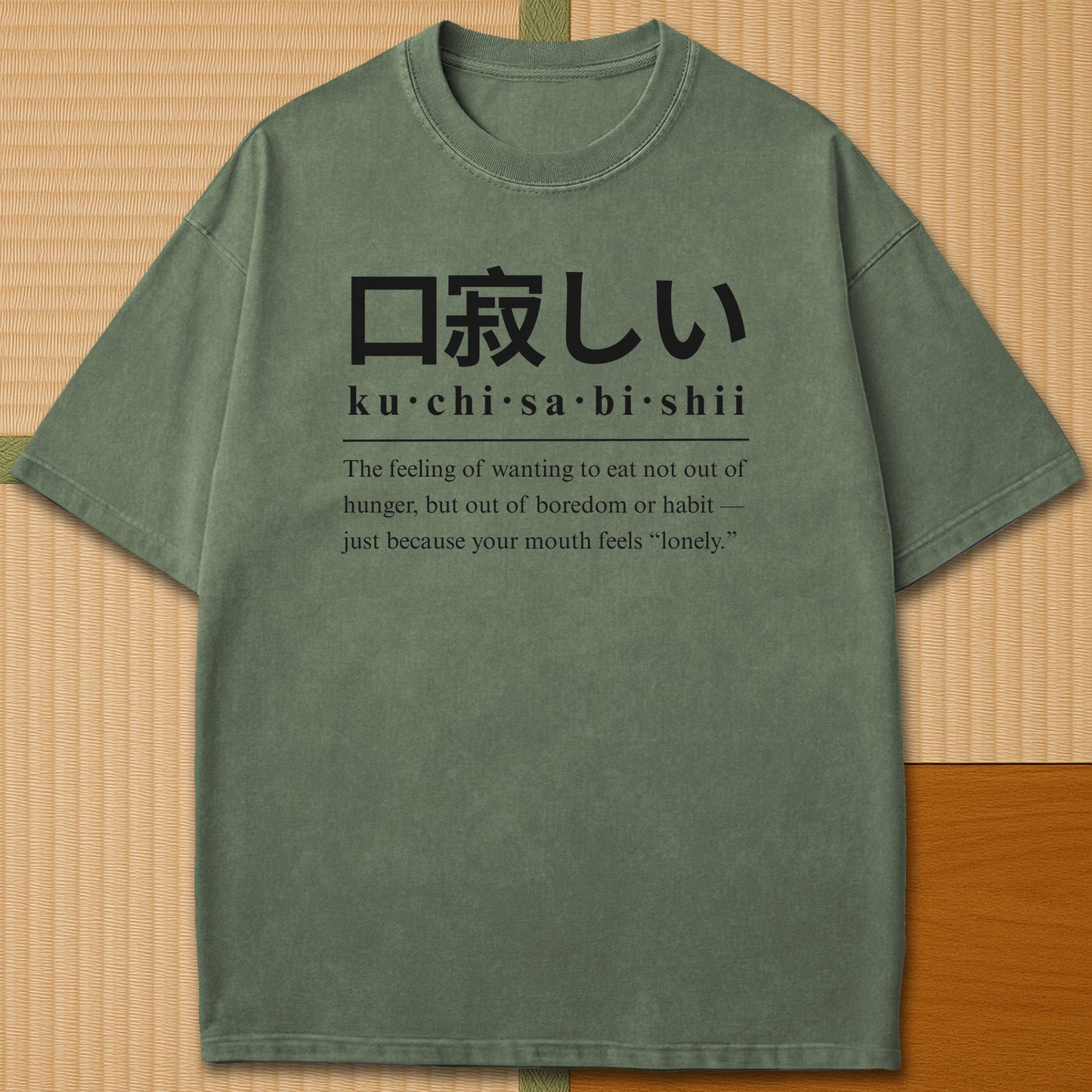 Japanese-inspired cotton Japanese Kuchisabishii Definition T-Shirt in Moss on Comfort Colors 1717, styled in a modern flatlay scene.
