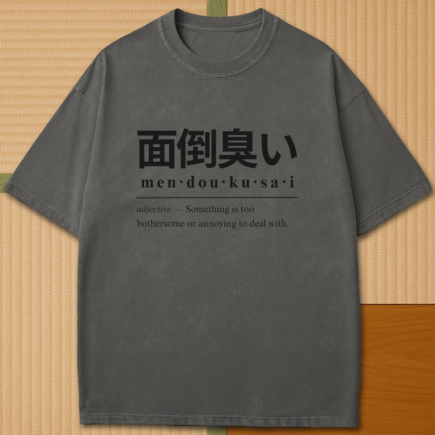 Japanese-inspired cotton Mendoukusai Japanese Dictionary T-Shirt in Pepper on Comfort Colors 1717, styled in a modern flatlay scene.