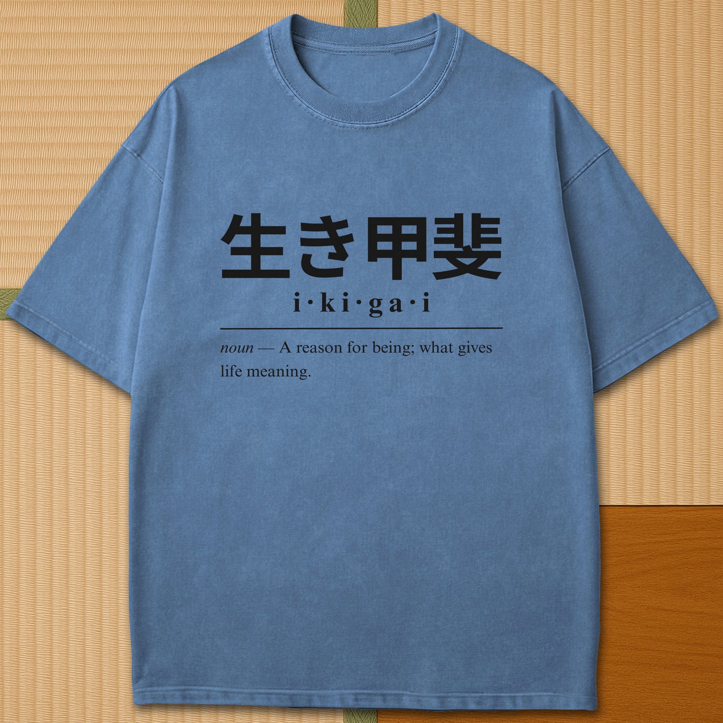Japanese-inspired cotton Ikigai Japanese Dictionary T-Shirt in Blue Jean on Comfort Colors 1717, styled in a modern flatlay scene.