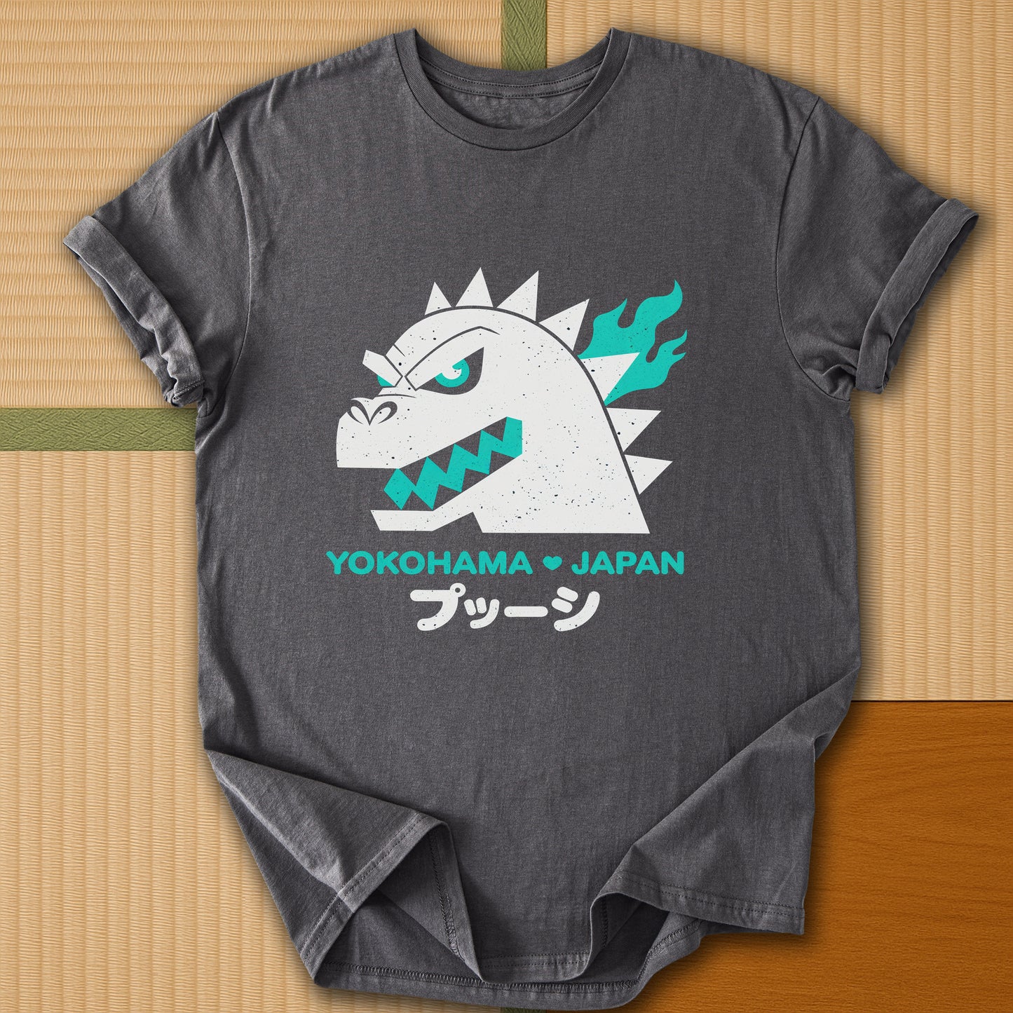 Japanese-inspired cotton Vintage Kaiju Godzilla T-Shirt in Charcoal on Gildan 64000, styled in a modern flatlay scene
