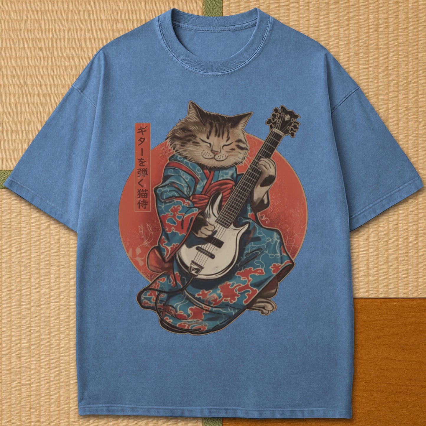 Japanese-inspired cotton Samurai Cat On Guitar T-Shirt in Blue Jean on Comfort Colors 1717, styled in a modern flatlay scene.