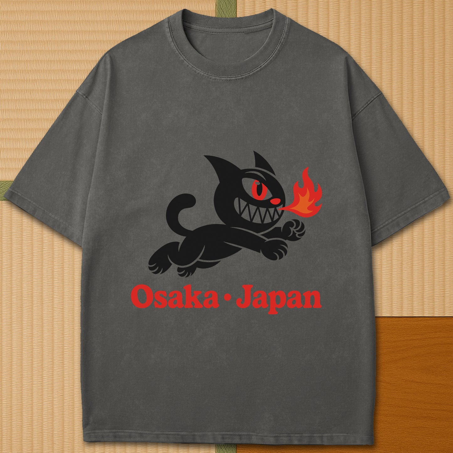 Japanese-inspired cotton Mischievous Cat Osaka T-Shirt in Pepper on Comfort Colors 1717, styled in a modern flatlay scene.