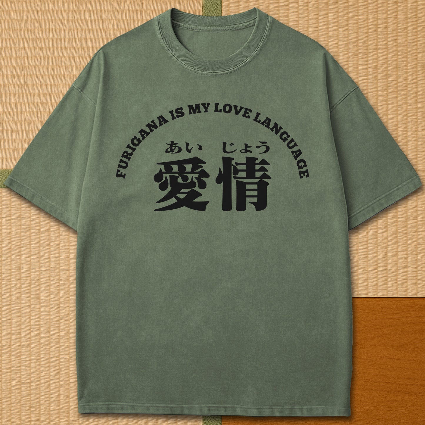 Japanese-inspired cotton Furigana Love Language T-Shirt in Moss on Comfort Colors 1717, styled in a modern flatlay scene.