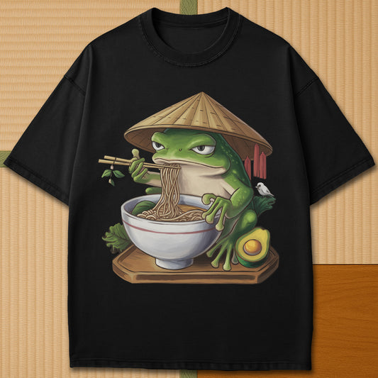 Japanese-inspired cotton Frog Eating Ramen T-Shirt in Black on Comfort Colors 1717, styled in a modern flatlay scene.