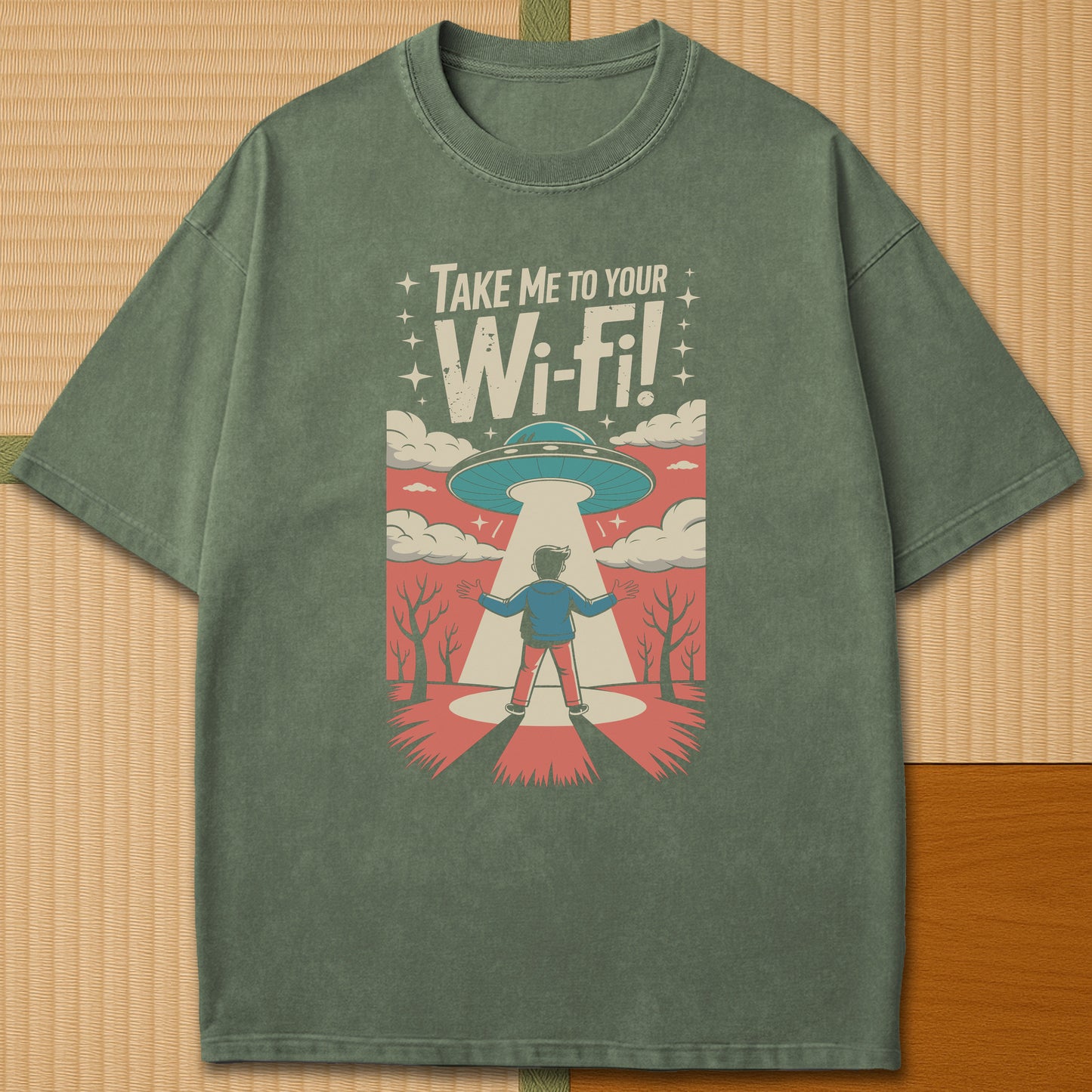 Japanese-inspired cotton Gaijin Abduction T-Shirt in Moss on Comfort Colors 1717, styled in a modern flatlay scene.