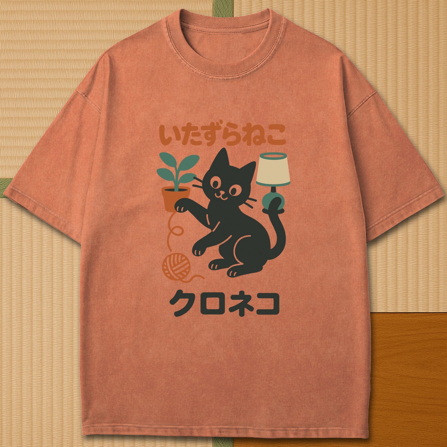 Japanese-inspired cotton Mischievous Black Cat T-Shirt in Yam on Comfort Colors 1717, styled in a modern flatlay scene.