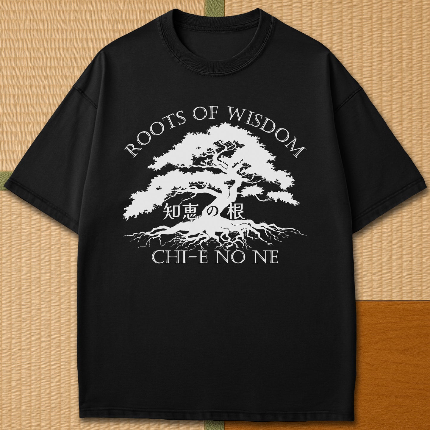 Japanese-inspired cotton Roots Of Wisdom T-Shirt in Black on Comfort Colors 1717, styled in a modern flatlay scene.