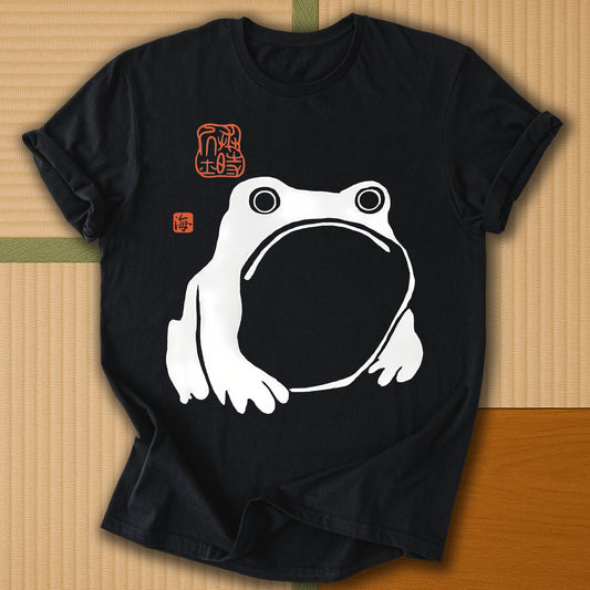Japanese-inspired cotton Frowning Frog Print T-Shirt in Black on Gildan 64000, styled in a modern flatlay scene
