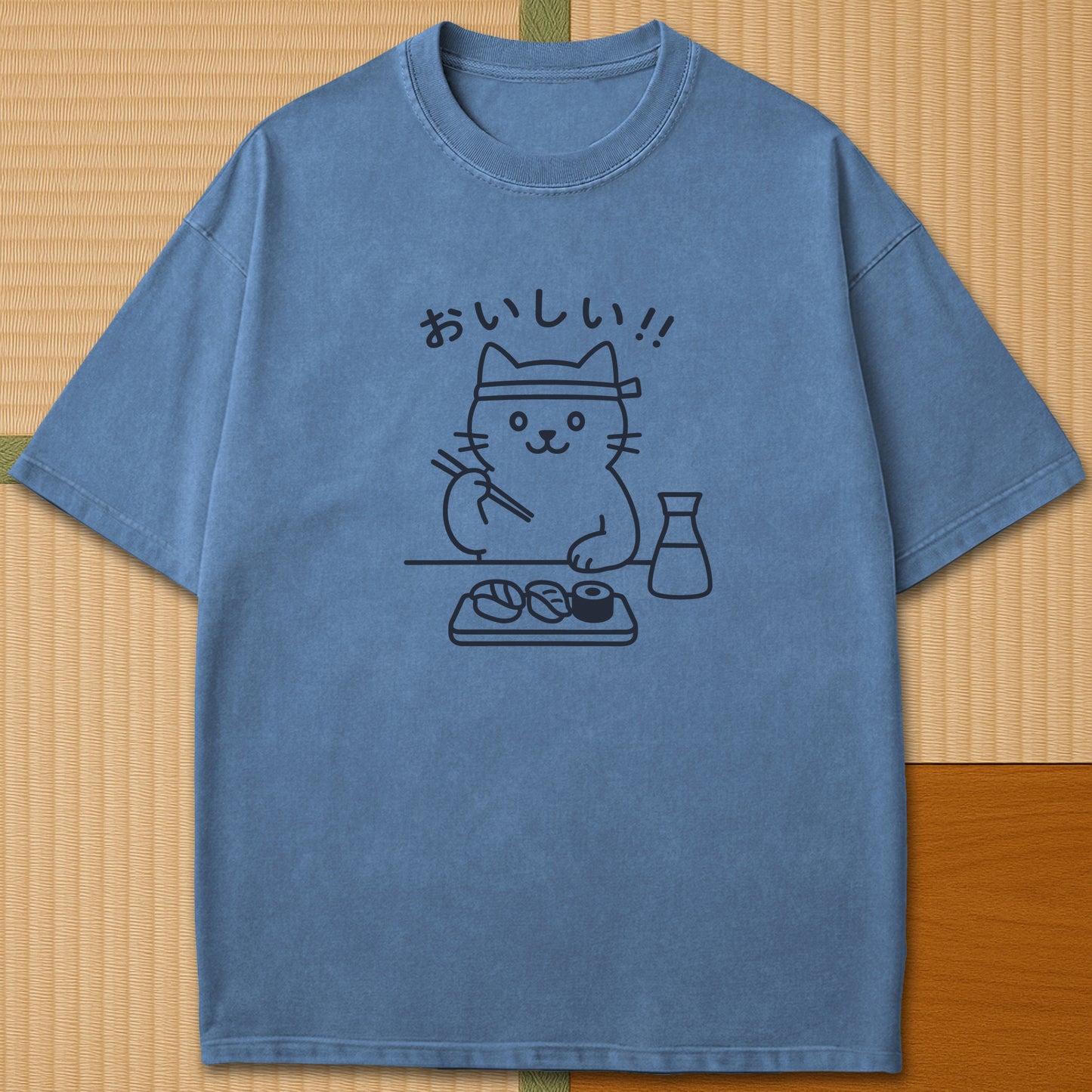 Japanese-inspired cotton Minimalist Cat & Sushi T-Shirt in Blue Jean on Comfort Colors 1717, styled in a modern flatlay scene.