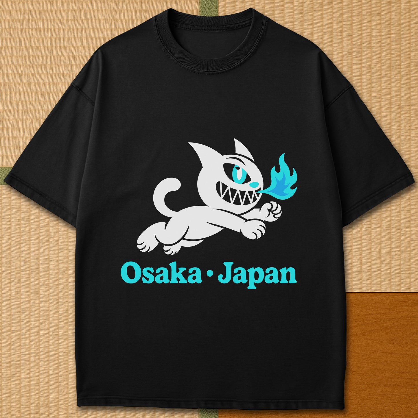 Japanese-inspired cotton Mischievous Cat Osaka T-Shirt in Black on Comfort Colors 1717, styled in a modern flatlay scene.